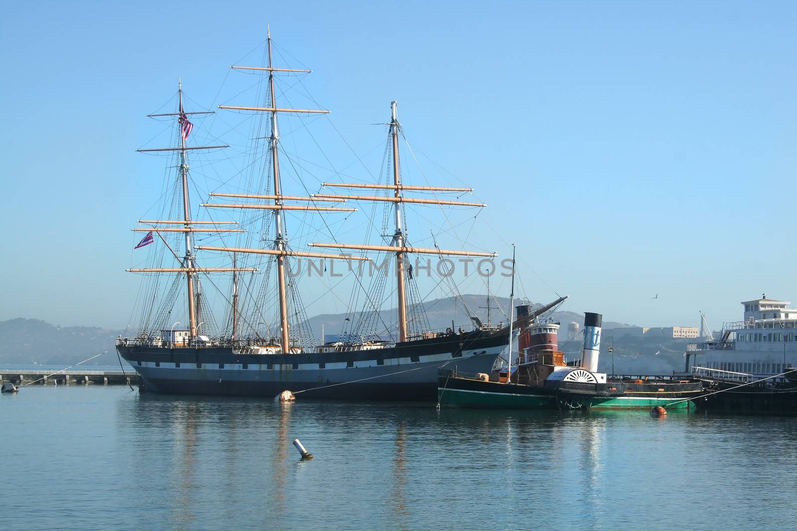 The tall ship Balclutha at the Hyde Street Pier in San Francisco with Alcatraz in the background.