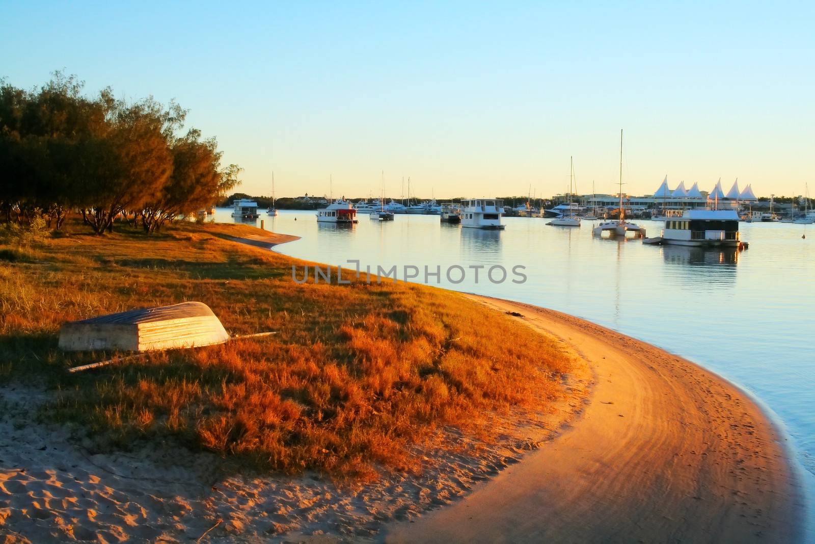Houseboats and yachts moored in the Broadwater Gold Coast Australia on a golden morning.