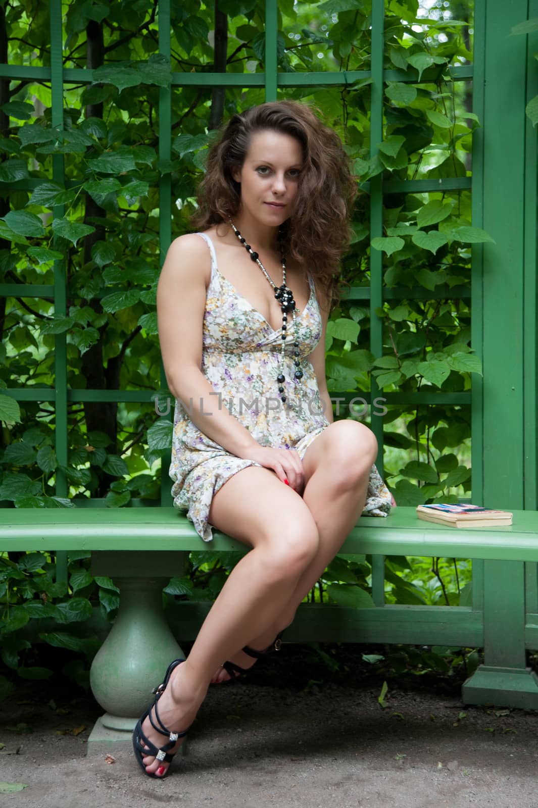 tired legs of a woman on a bench in the summer