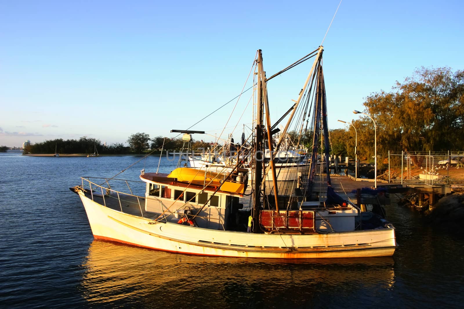 Prawn trawlers at dock at sunset tied up for the night.