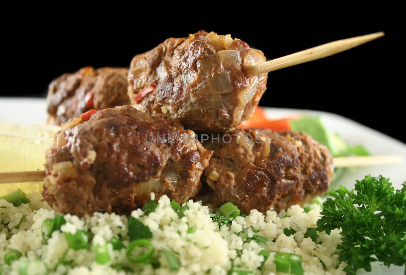 Beef kofta on parsley couscous with a garden salad.