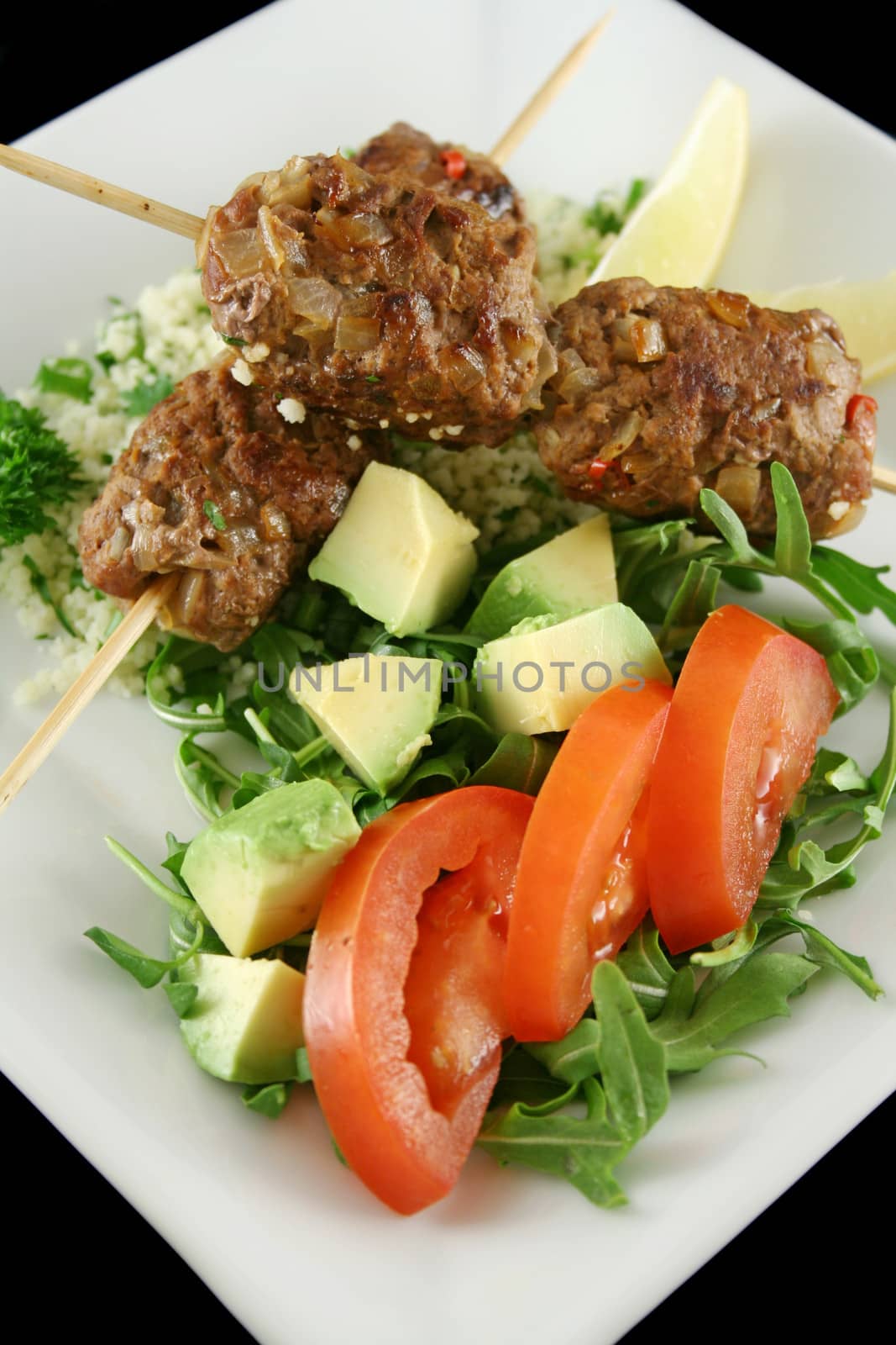 Beef koftas on parsley couscous with a garden salad.