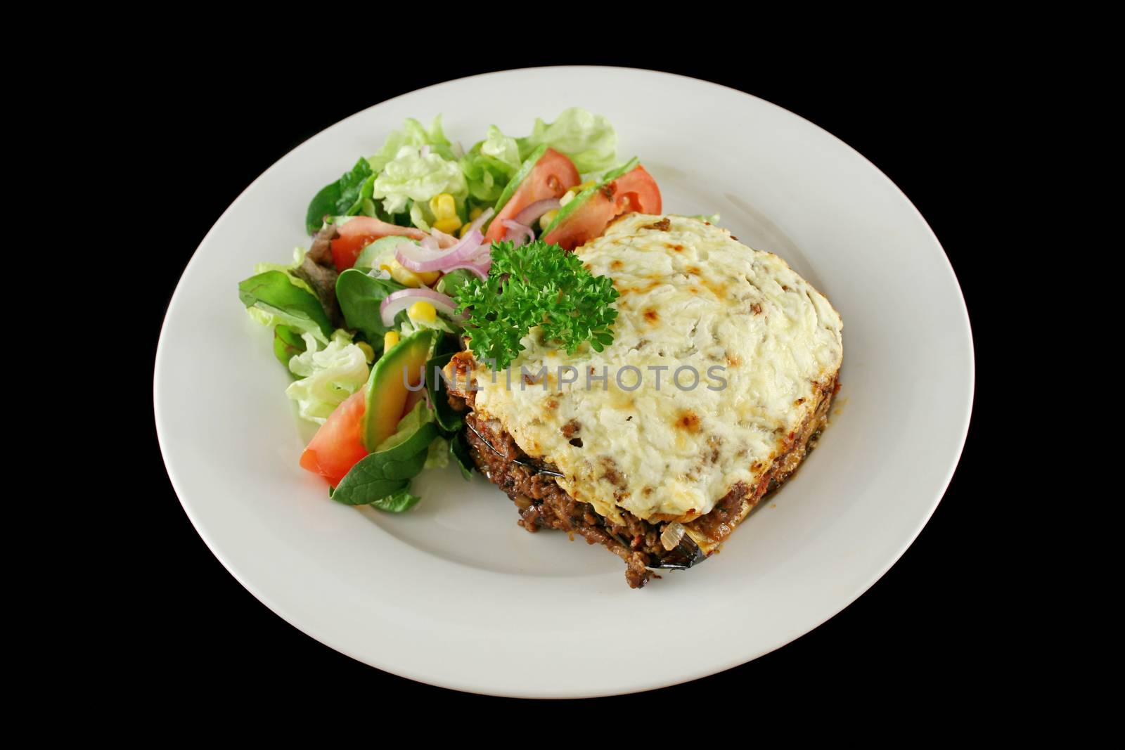 Lamb moussaka with egg plant cheese and salad.