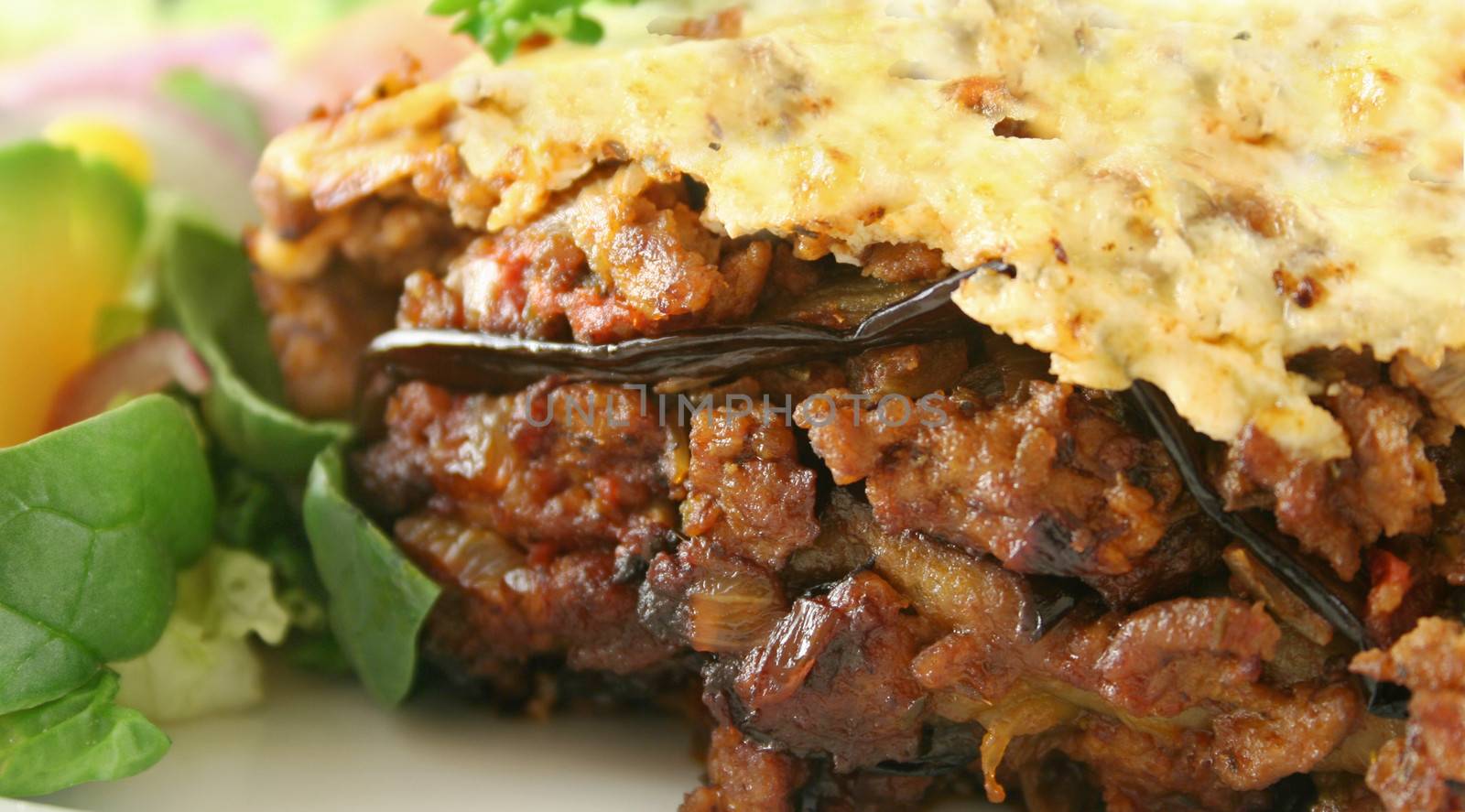 Lamb moussaka with egg plant cheese and salad.