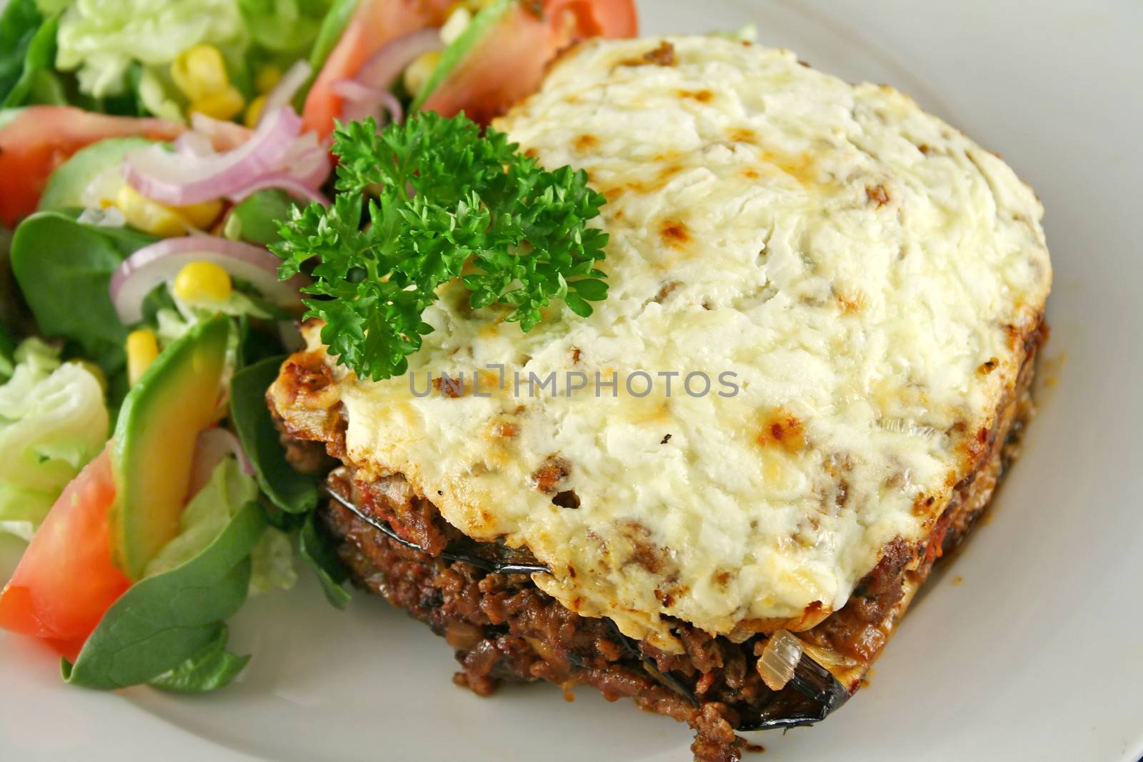 Lamb moussaka with egg plant cheese and salad.