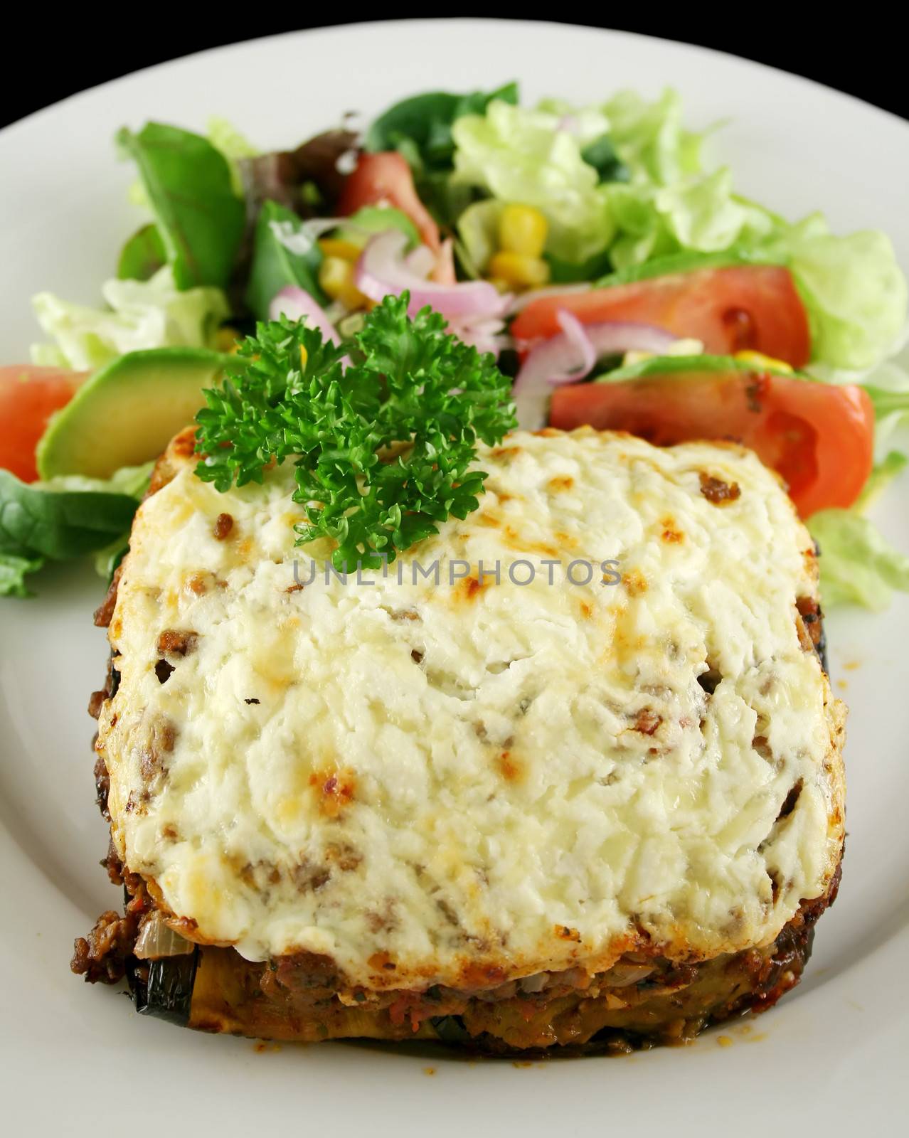 Greek lamb moussaka with egg plant cheese and salad.