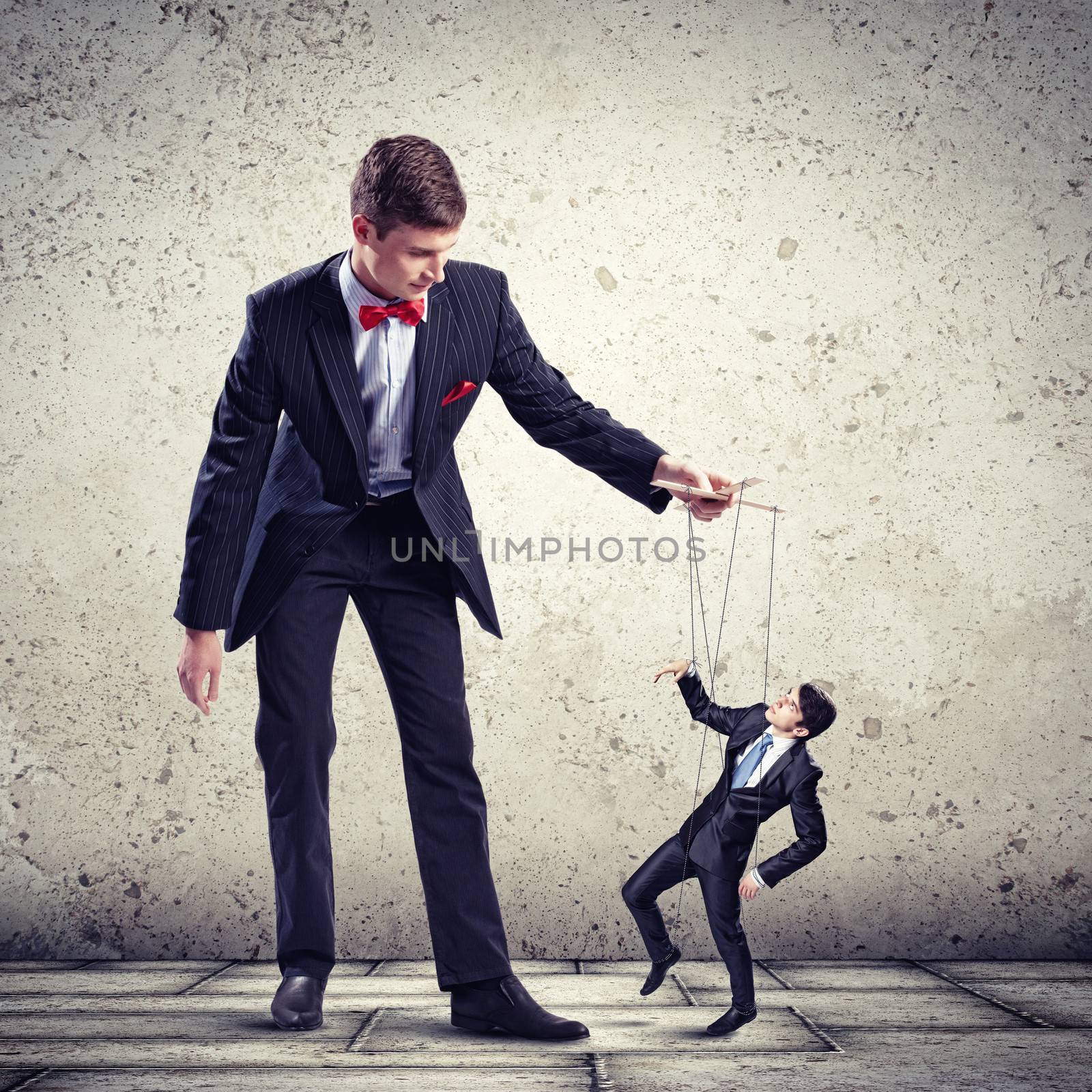 Image of young businessman puppeteer. Leadership concept