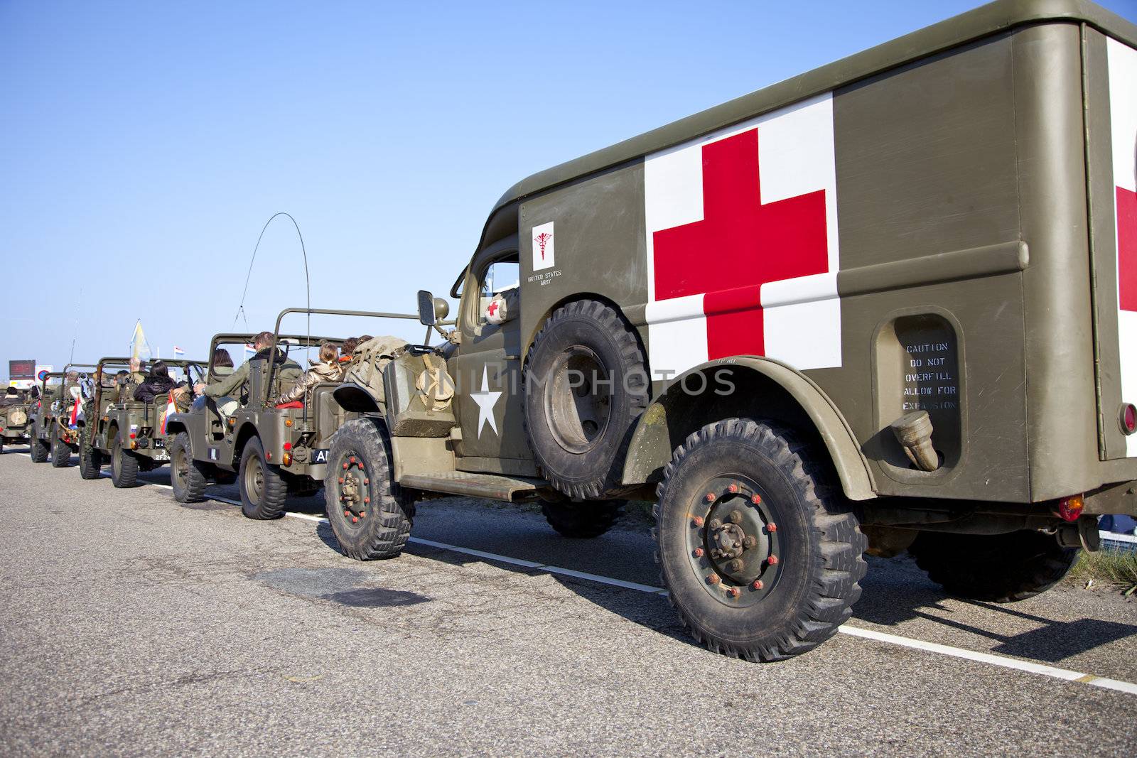 IJMUIDEN, THE NETHERLANDS-MAY 5 2013: Army trucks of organization Kelly's Heroes riding on beach on May 5,2013 in IJmuiden, The Netherlands. Simulate arrival of allies on liberation Second World War