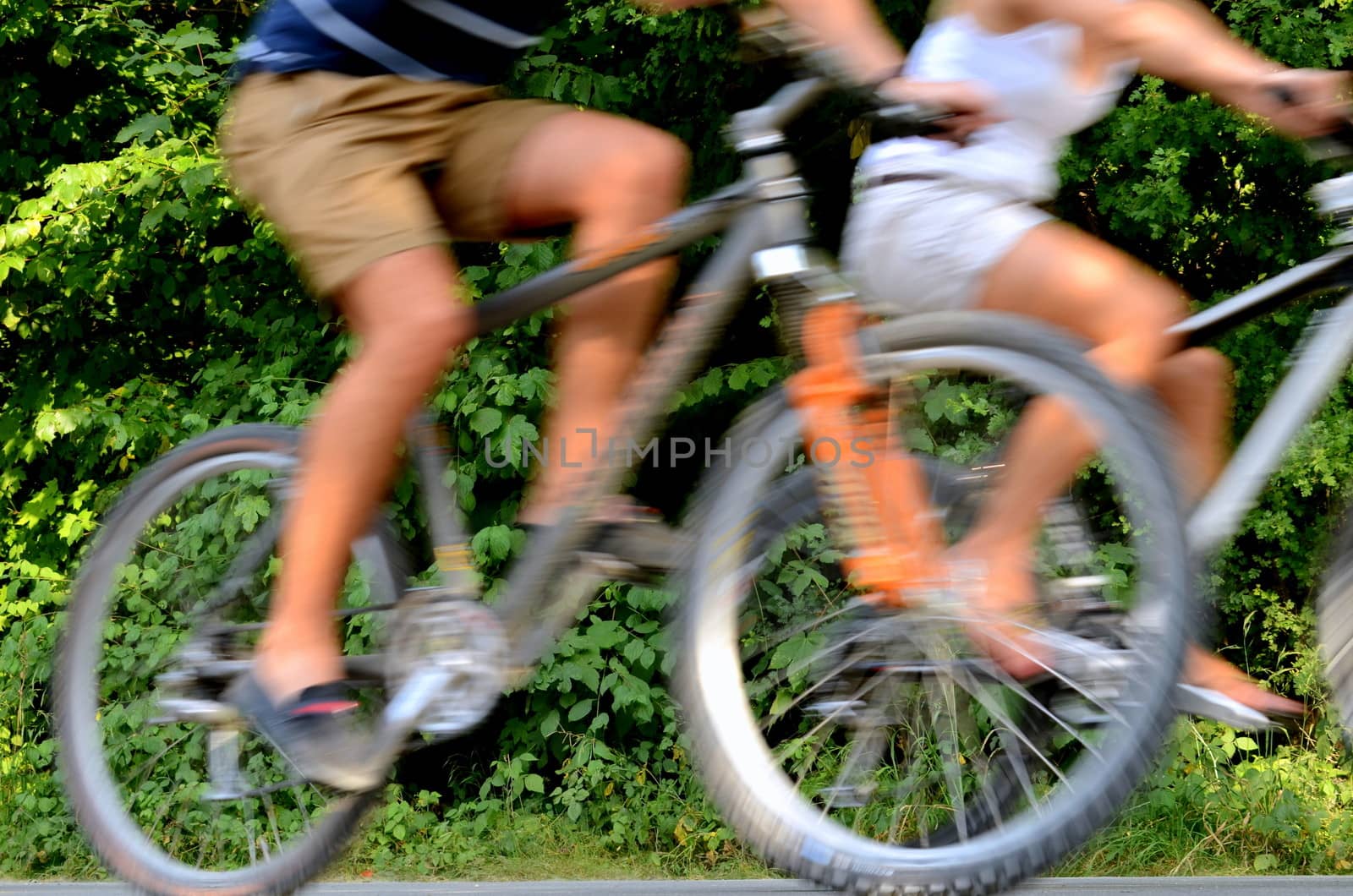 Healthy Lifestyle Image Of A Couple Cycling WIth Blurred Motion