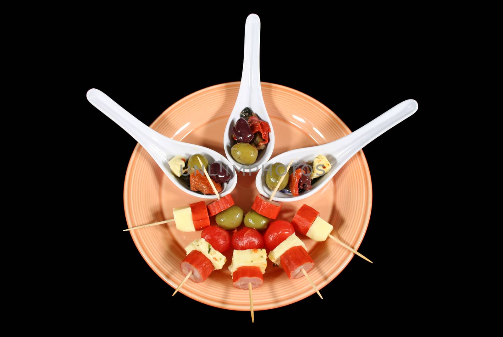 Delightful antipasto presented on spoons and toothpicks.