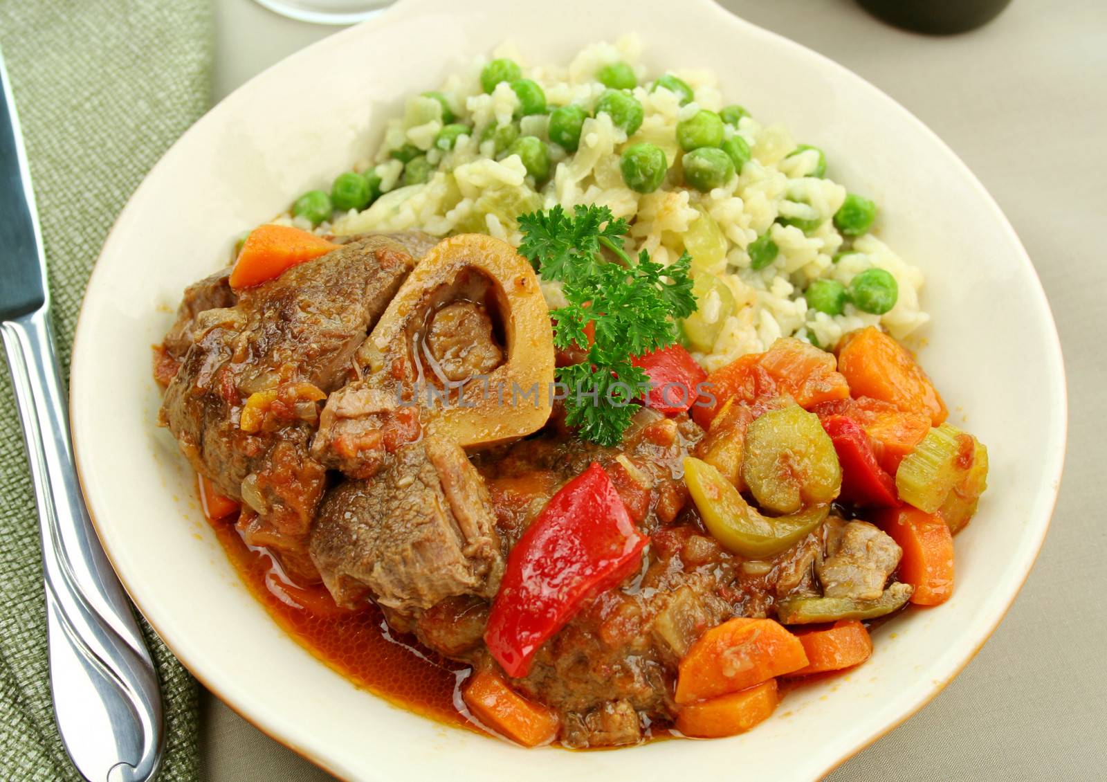 Slow roasted osso bucco with a green pea rice ready to serve.