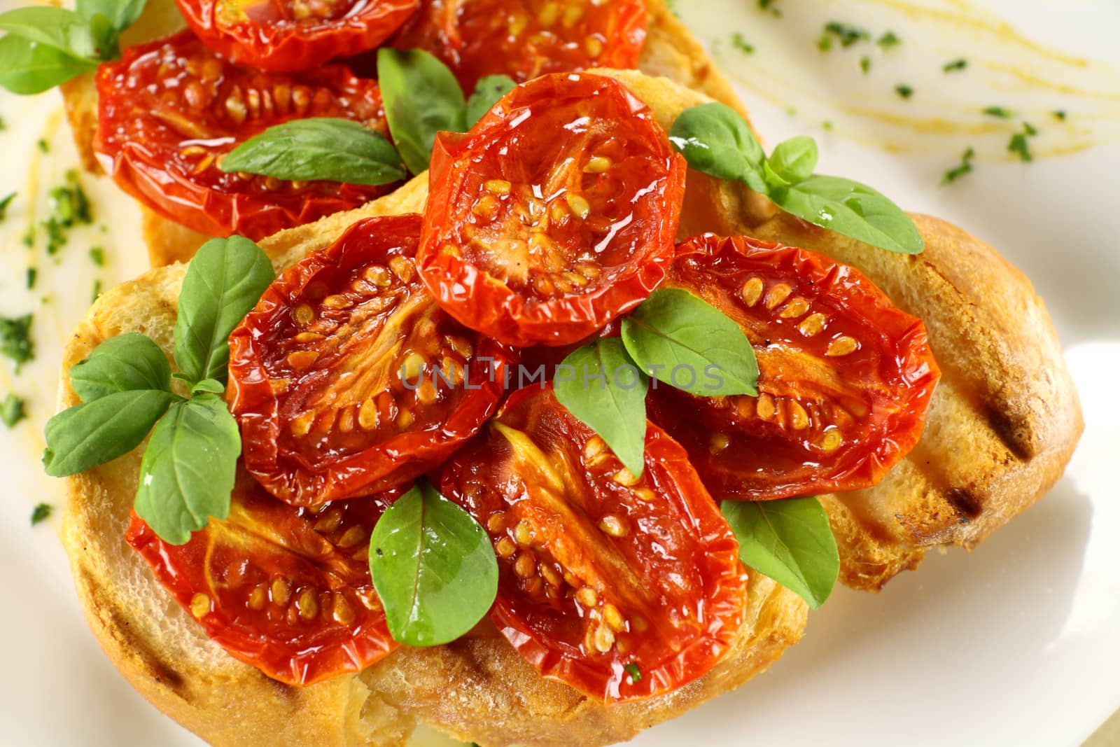 Delicious roasted cherry tomatoes with basil on bruschetta.