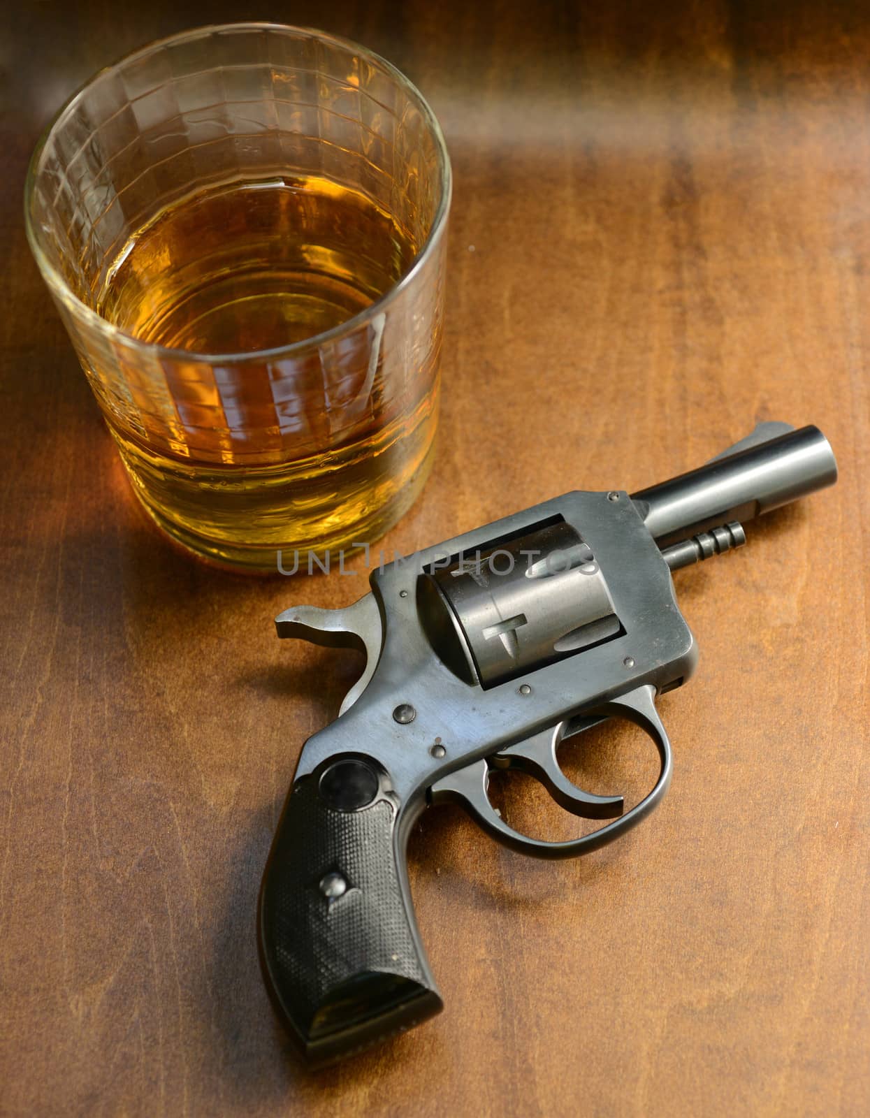 gun with alcohol on a rustic wood background