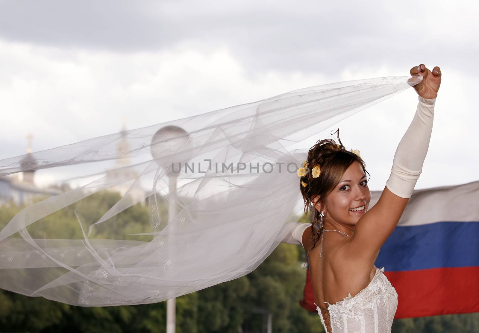 The happy bride on a background of the Russian flag