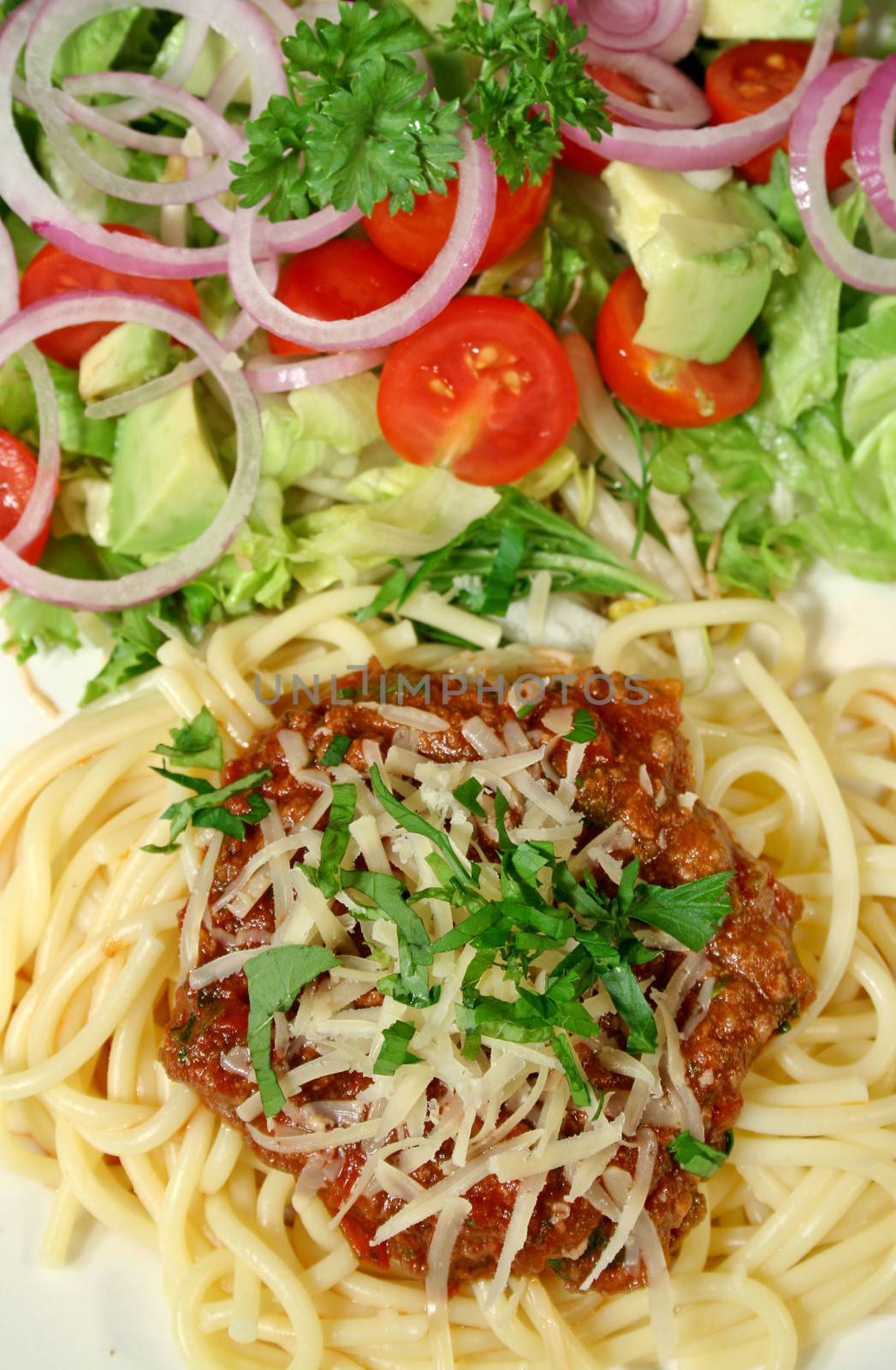 Delightful spaghetti bolognese and salad.