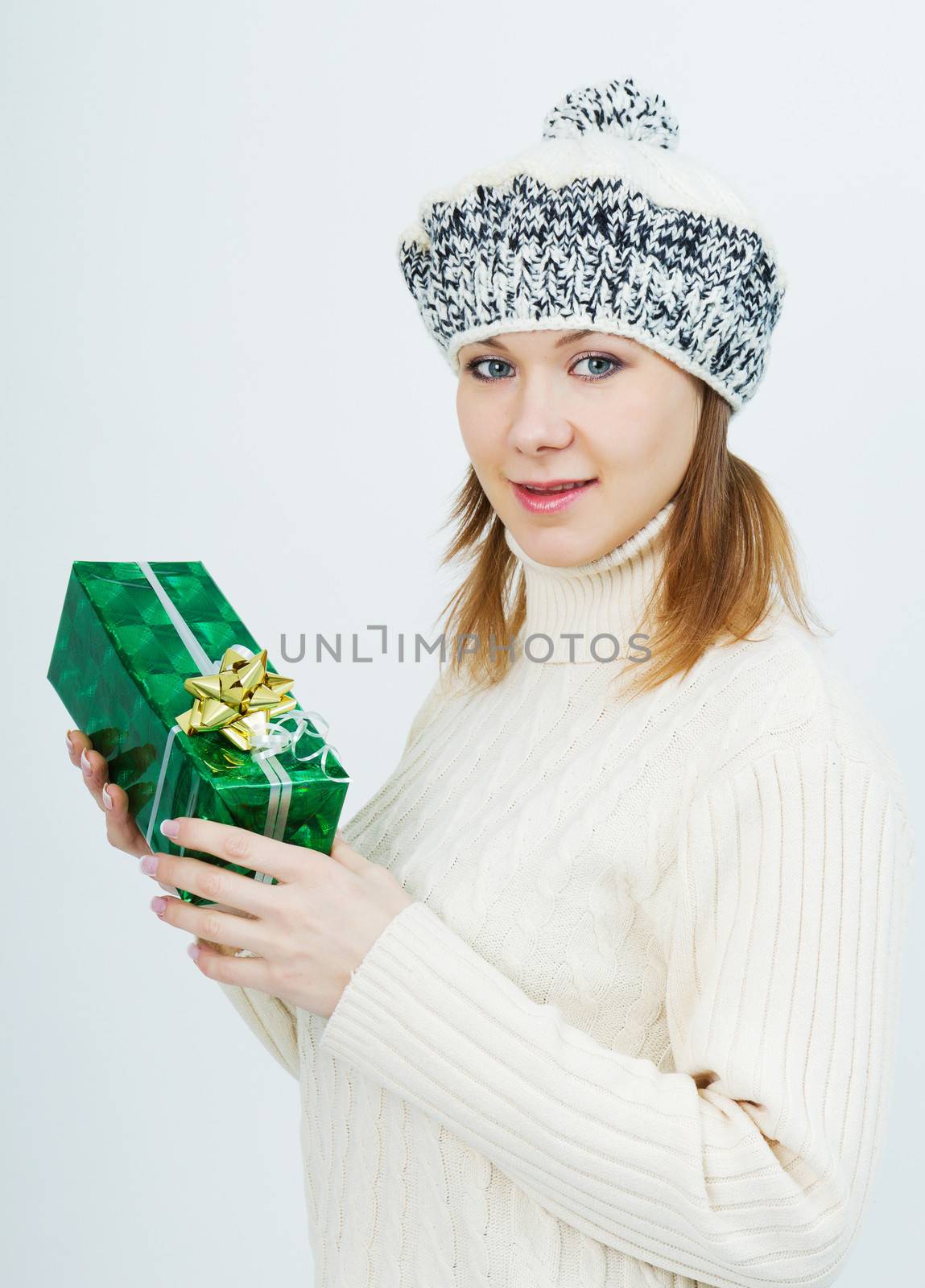 attractive girl in a sweater with a gift in their hands