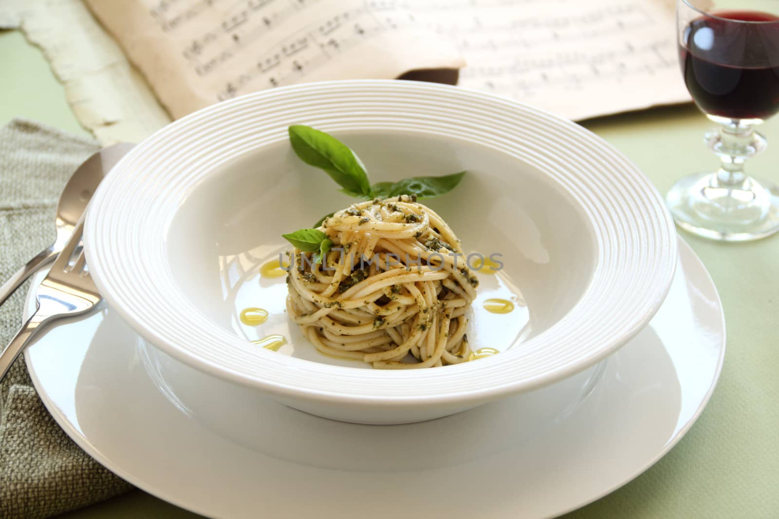Delicious spaghetti with pesto with red wine ready to serve.