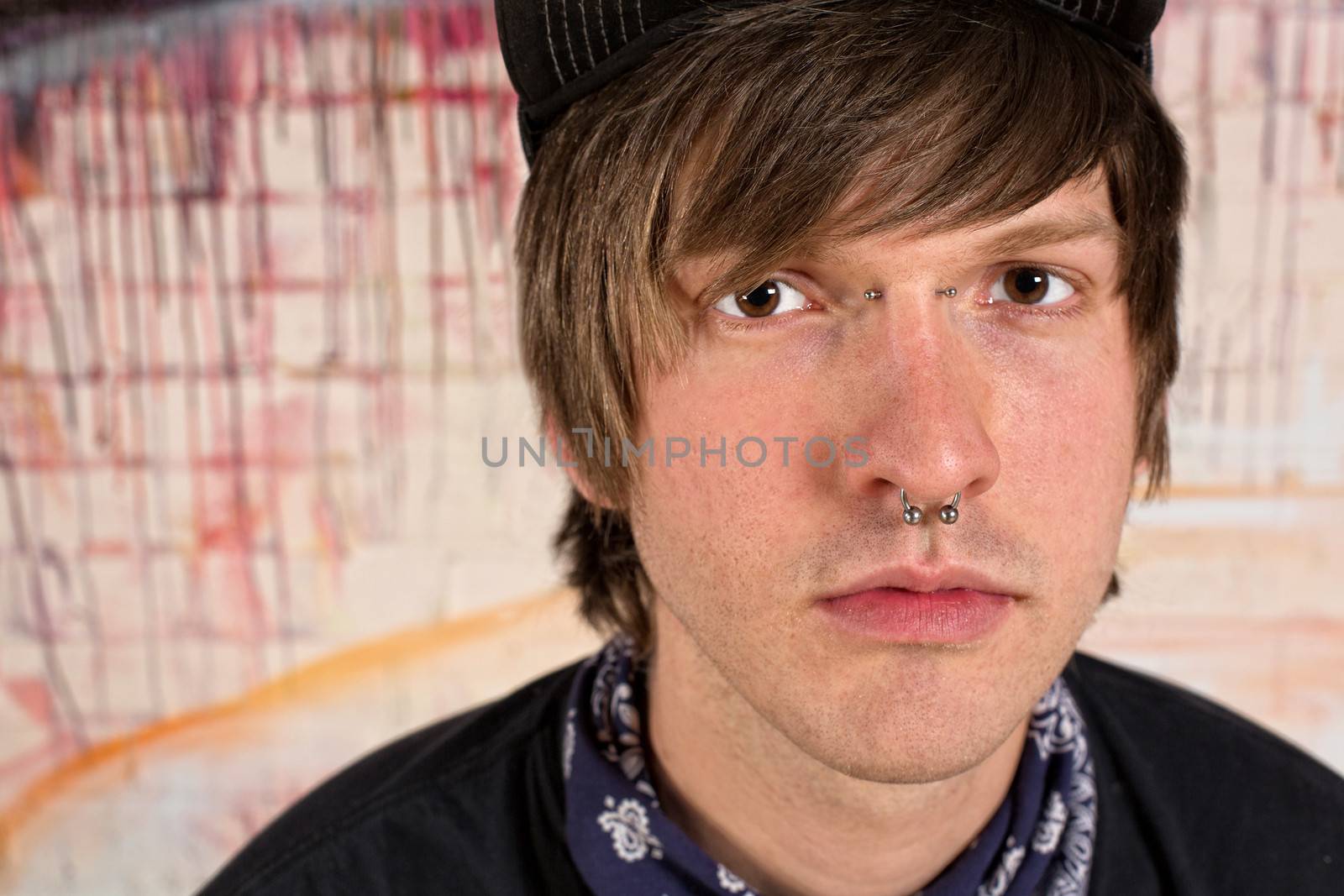 Serious young male teen with nose ring