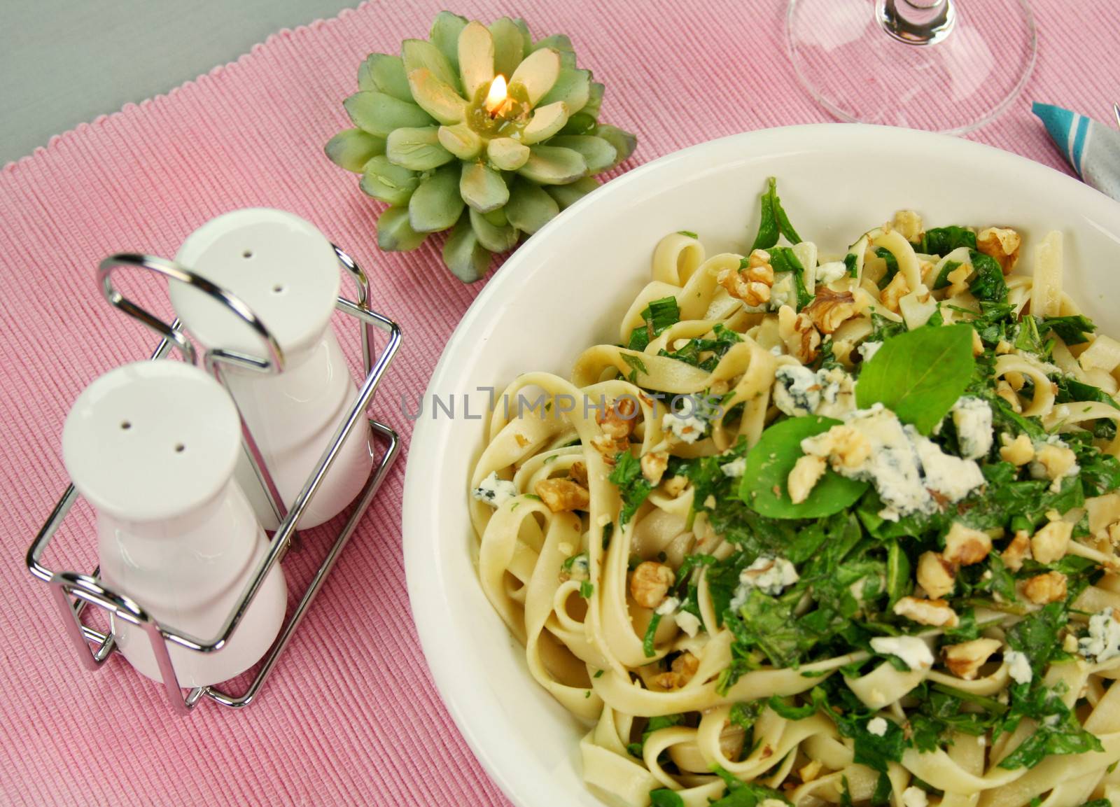 Fettucini with spinach blue cheese and walnuts with a mint garnish.