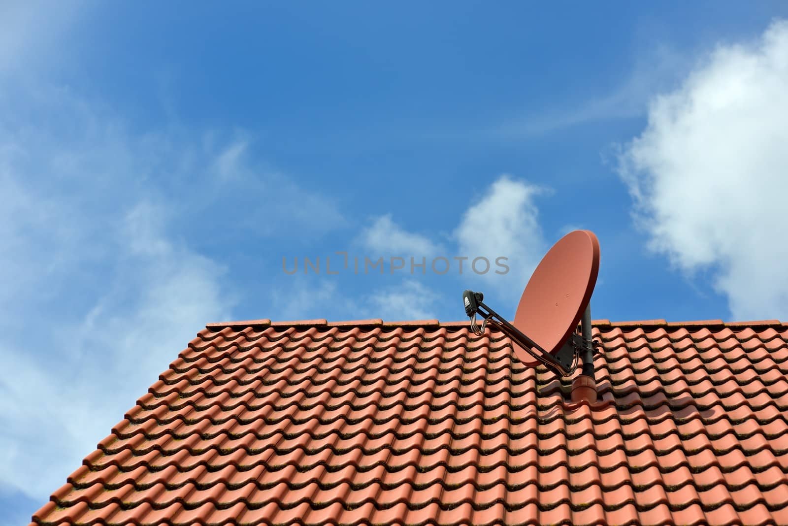 A satellite dish on a house roof