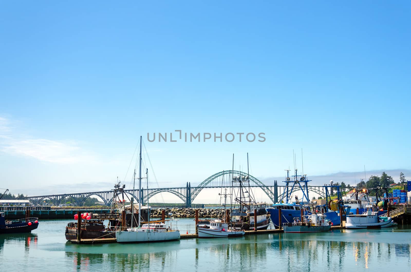 Yaquina Bay bridge with boats in the foreground in Newport, Oregon
