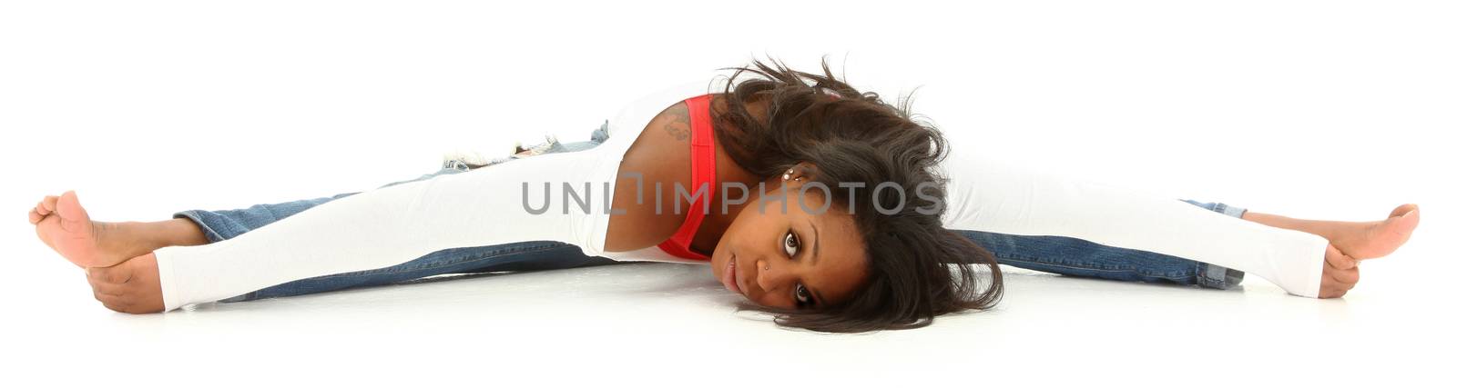Beautiful black woman doing a split on white floor. Clipping path.