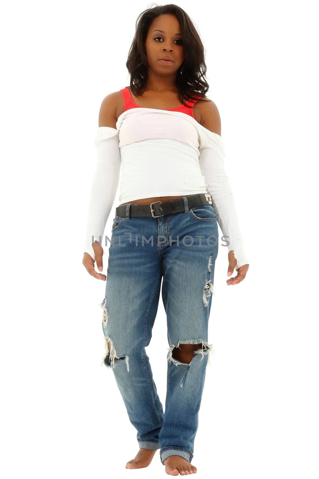 Beautiful black woman in torn jeans and white shirt standing on white floor. Clipping path.