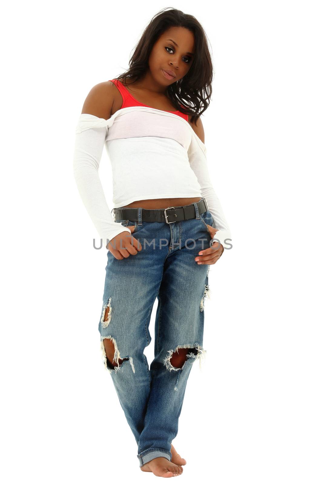 Beautiful black woman in torn jeans and white shirt standing on white floor. Clipping path.