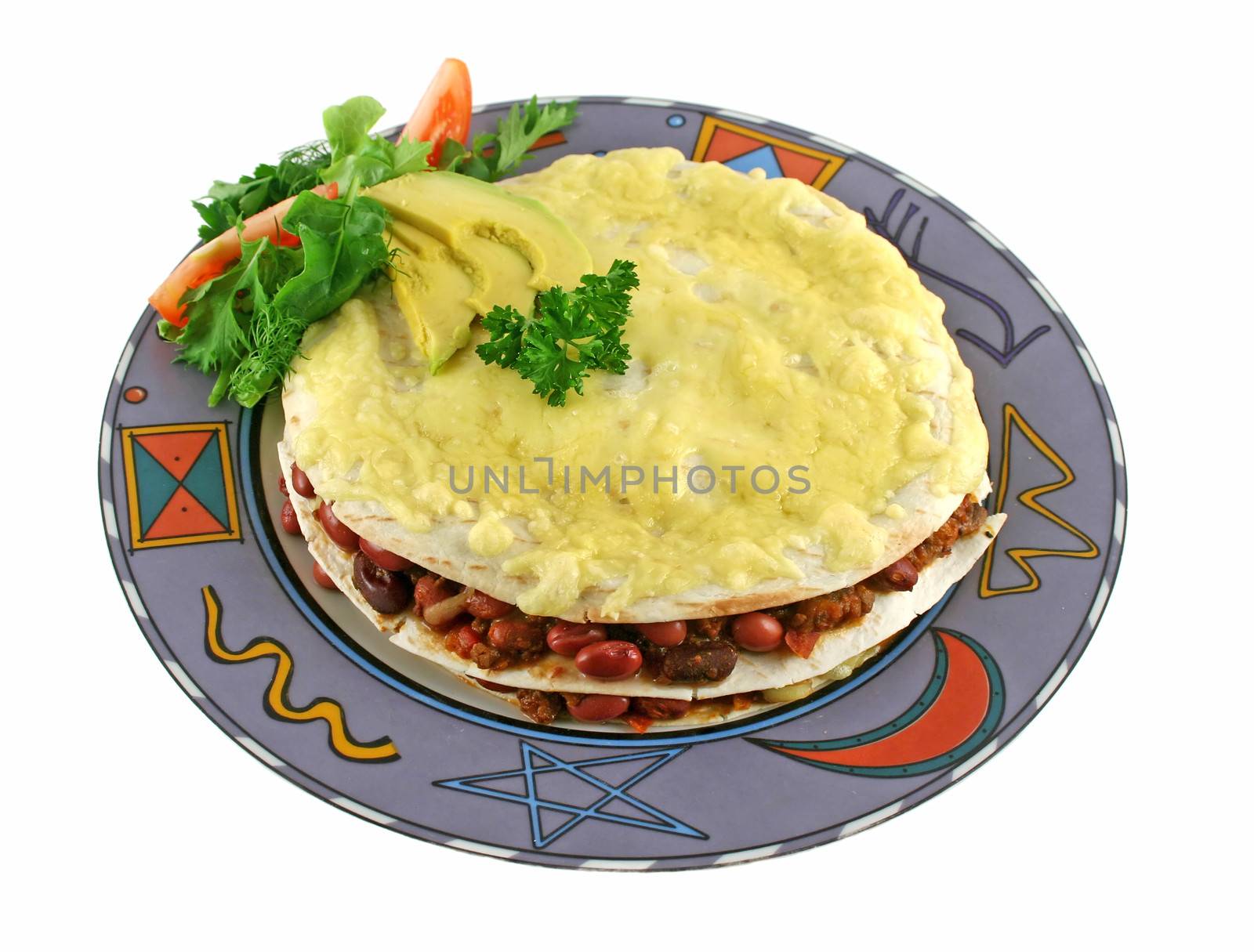 A beef and bean Mexican tortilla stack with cheese and salad.