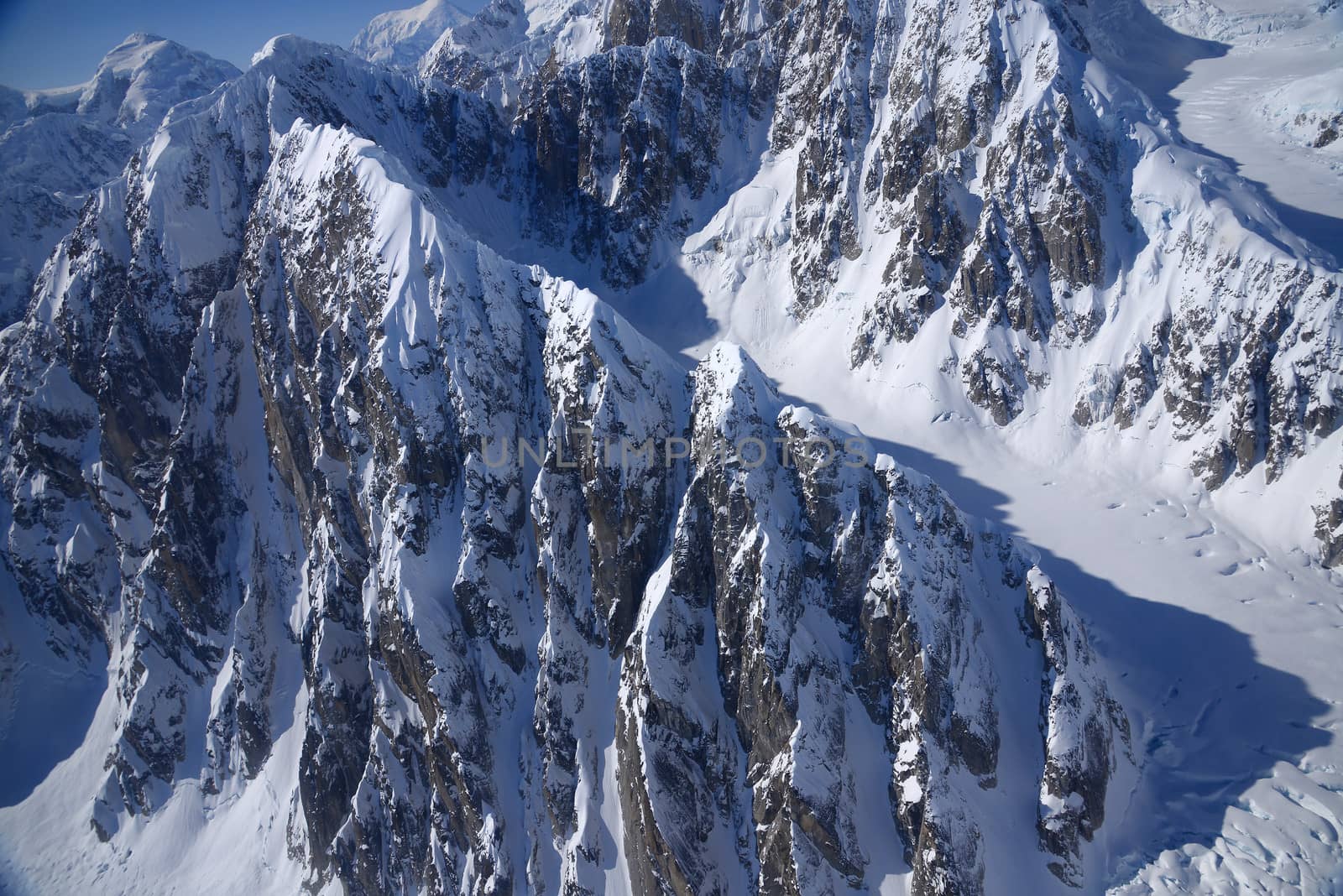 rock cliff on alaska mountain in winter, with snow covered