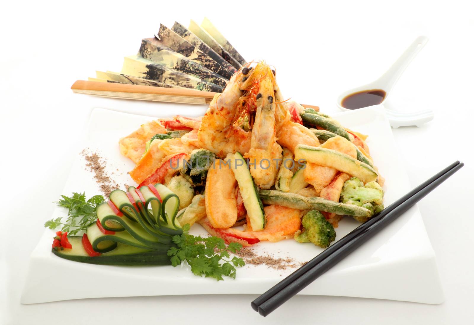 Japanese fried tempura with shrimp and vegetables with zucchini garnish.