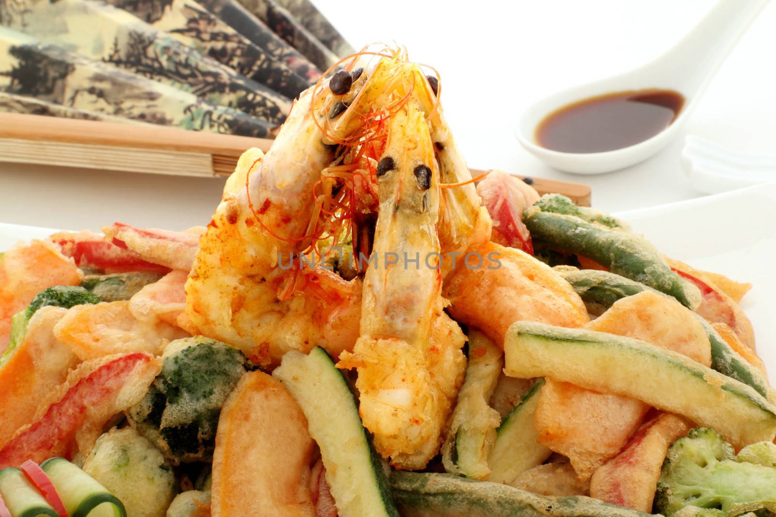 Japanese fried tempura with shrimp and vegetables with zucchini garnish.