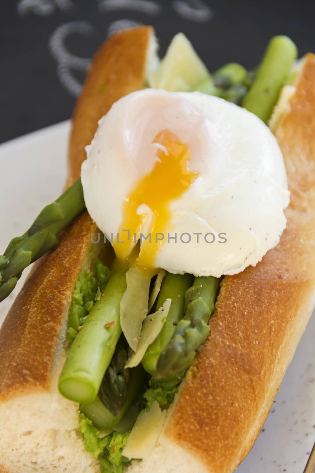 Delicious asparagus and mashed peas topped with a poached runny egg on a crispy baguette.