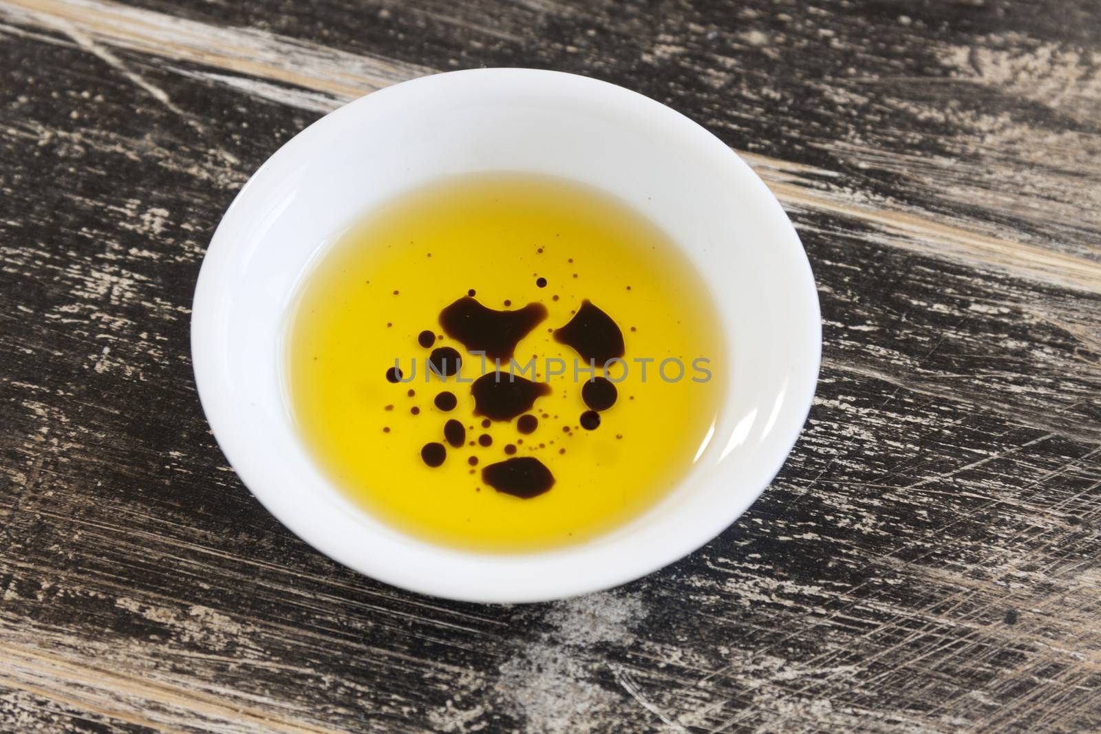 Dipping condiment of olive oil and balsamic vinegar ready to serve.