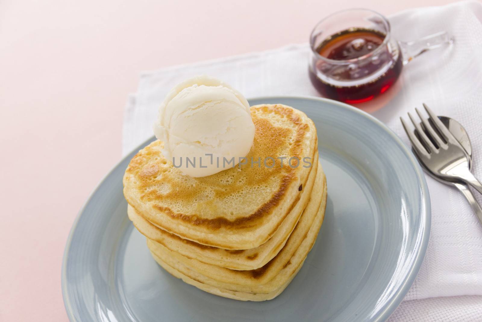 Delightful heart shaped pancakes served with vanilla ice cream and maple syrup.