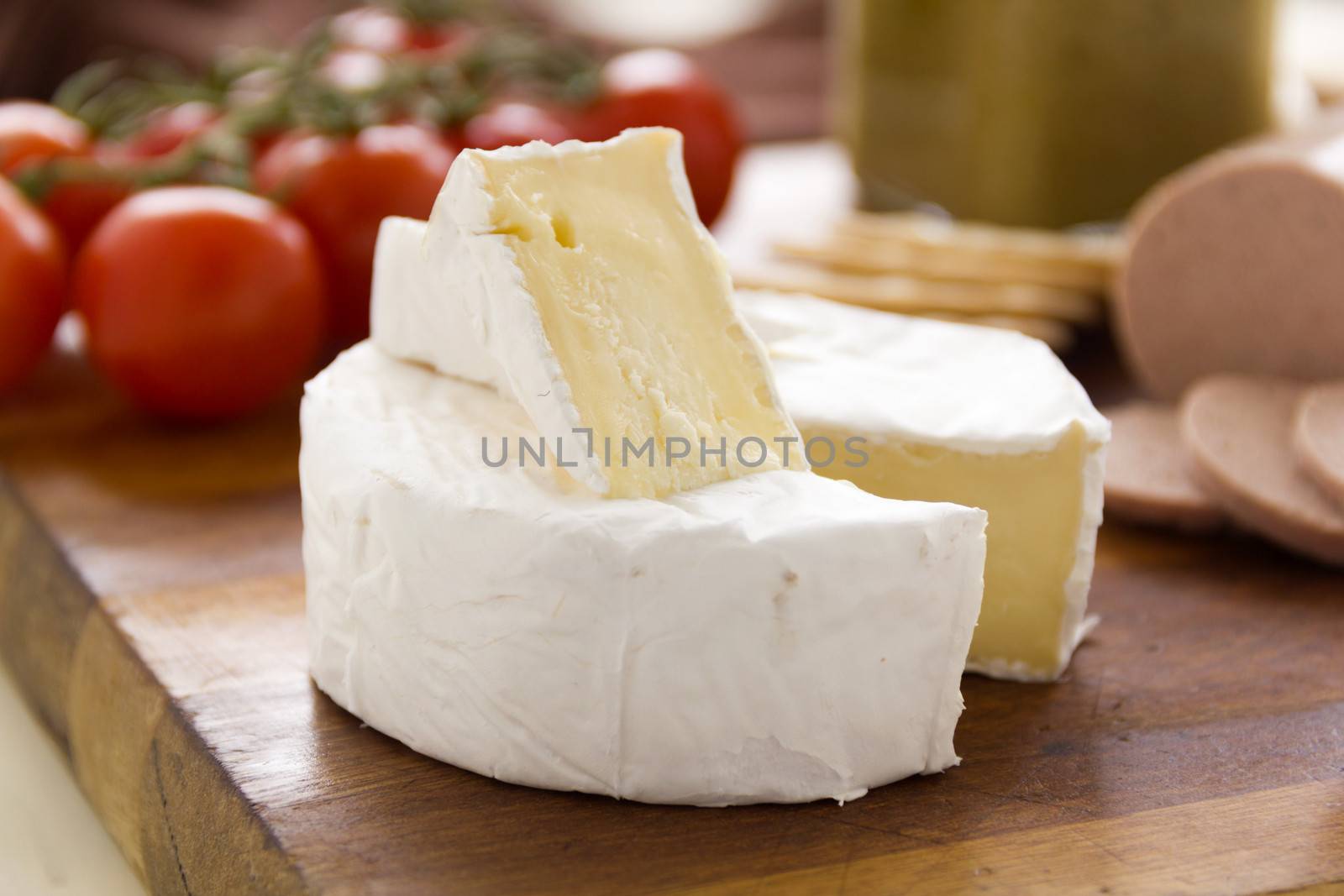Delicious creamy camembert cheese with crackers and cherry tomatoes.