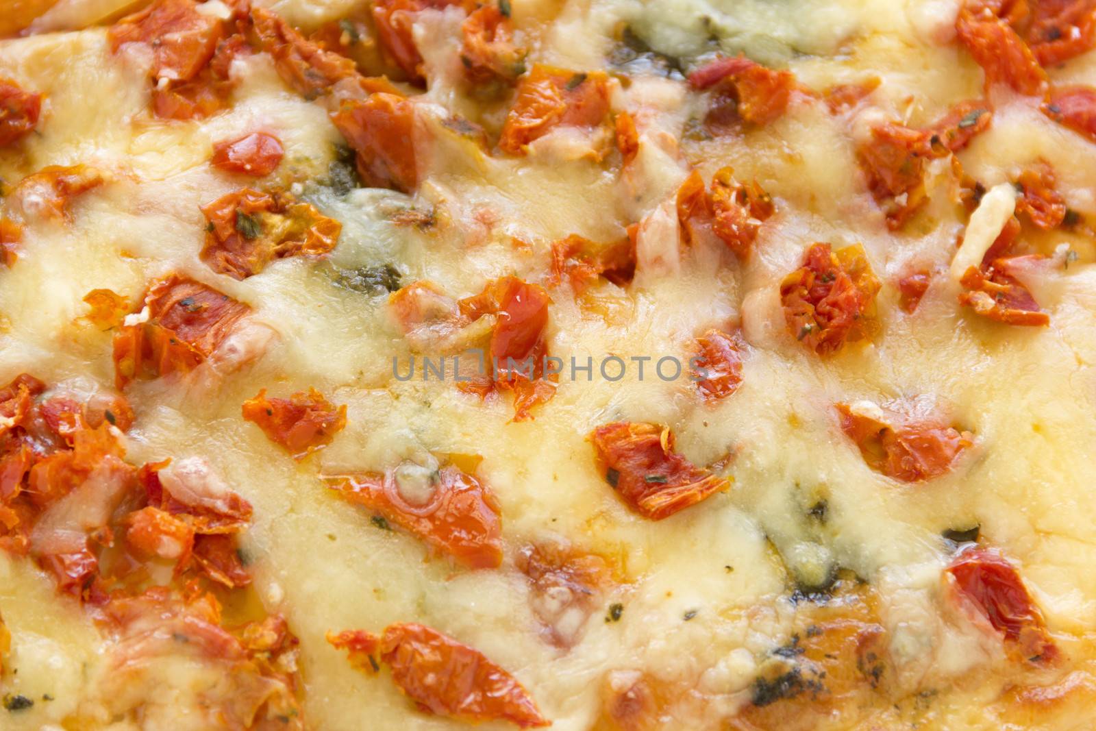 Close up of a delicious wood fired pesto marguarita pizza ready to serve.