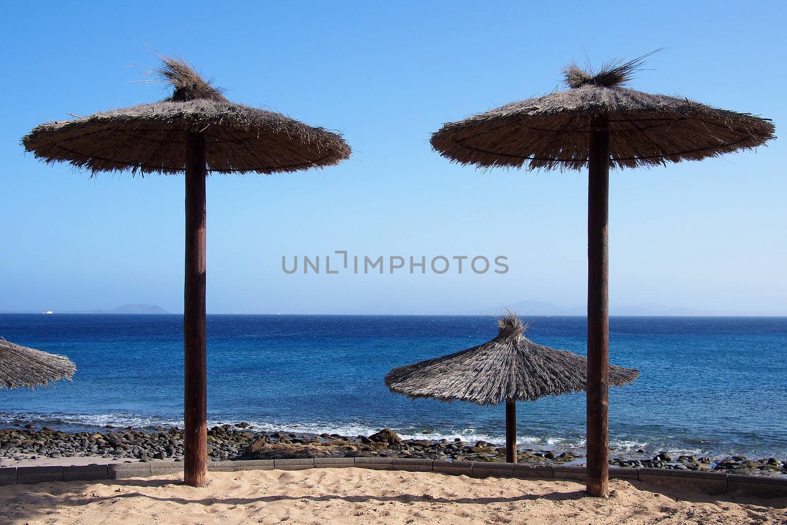 Thatched-roof umbrellas at the beach