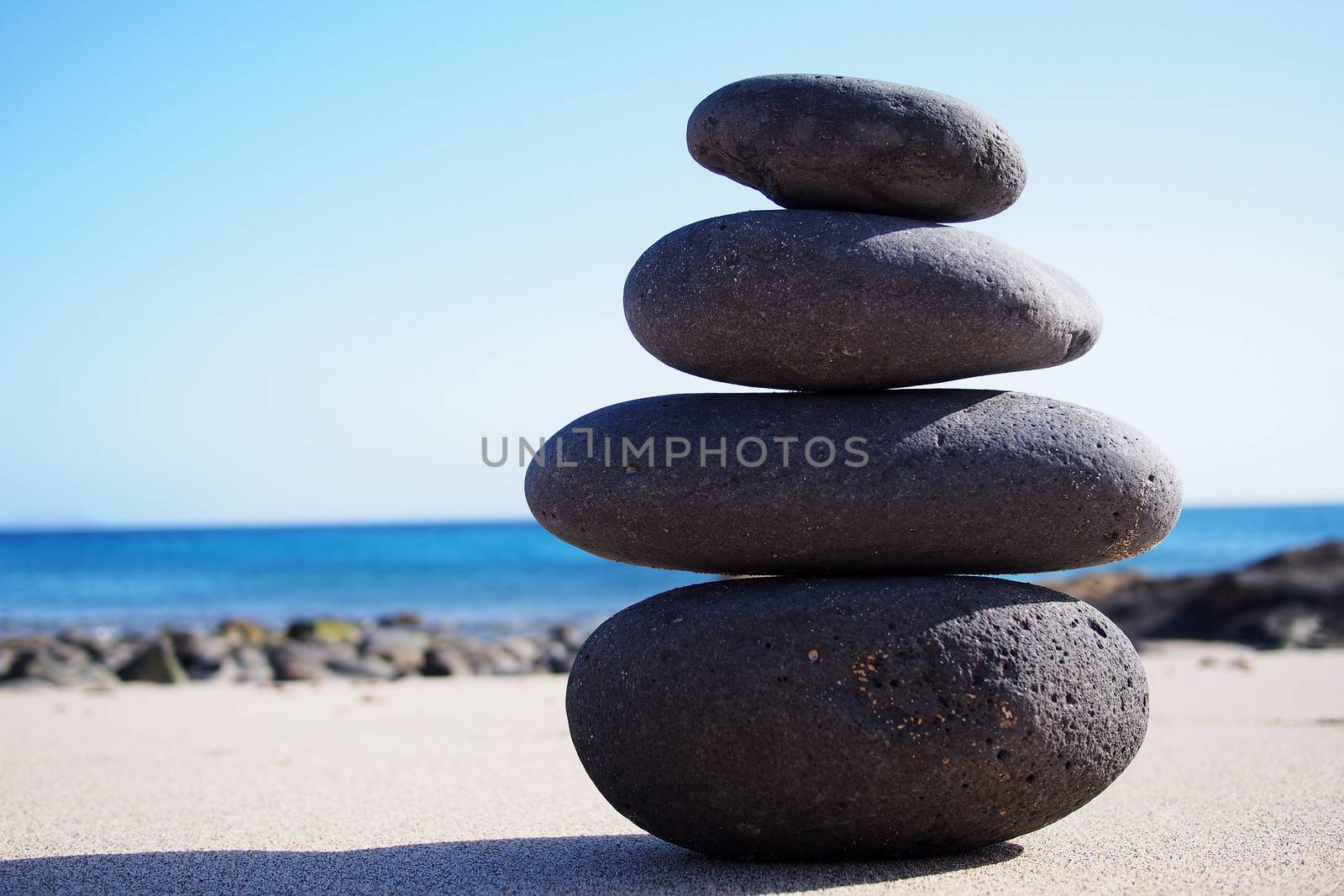 Stack of zen stones on the sand by stockyimages