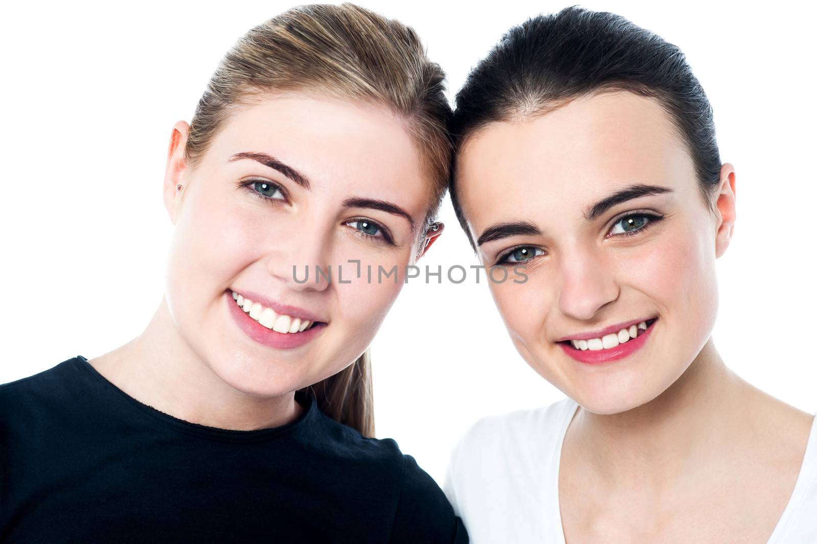 Young smiling girls looking at you by stockyimages