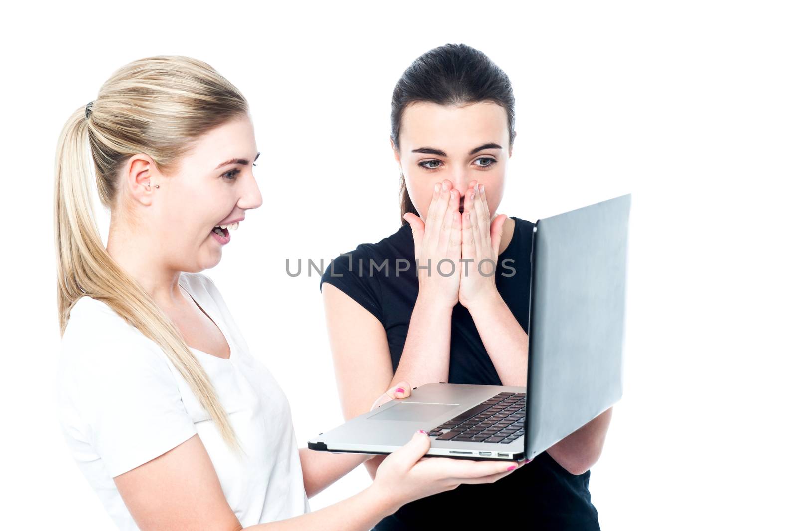Pretty teen girls surprised after what they saw in laptop