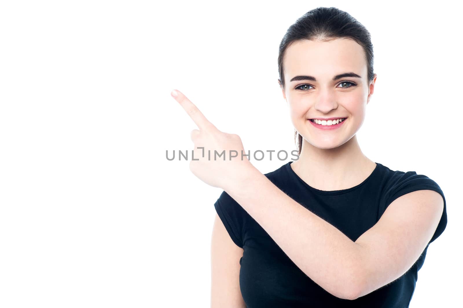 Smiling young girl pointing away by stockyimages