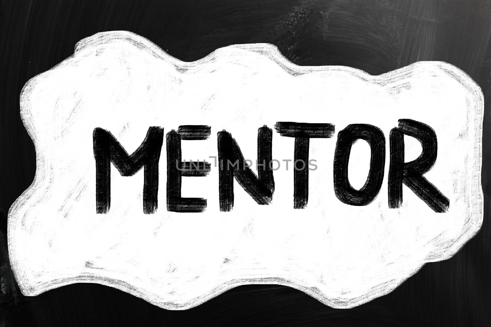 "Mentor" handwritten with white chalk on a blackboard.
