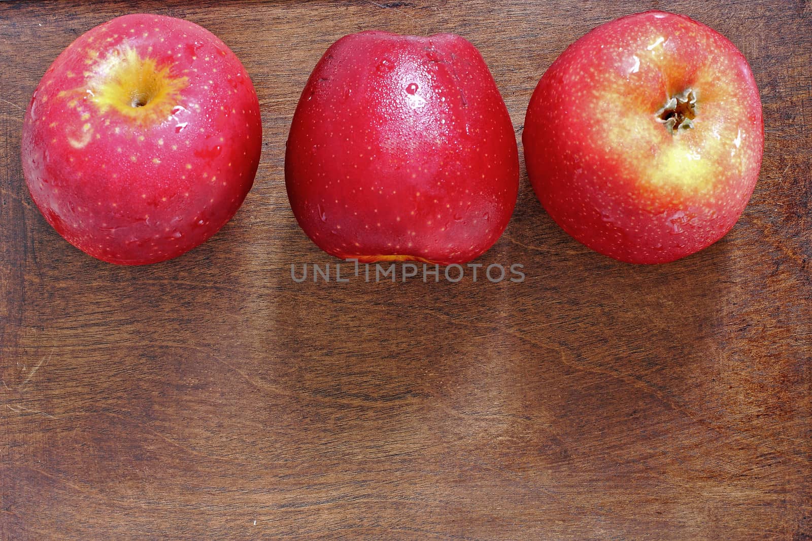 Three apples on wood  by myrainjom01