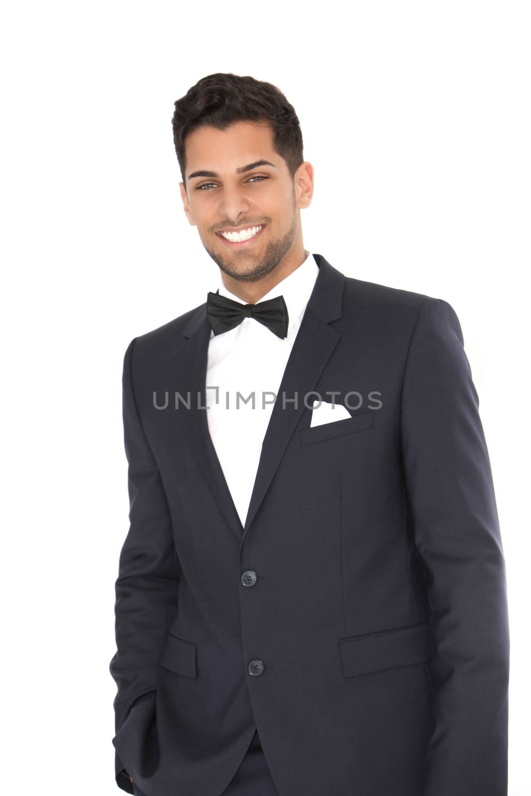 Smiling handsome groom in black suit against the white background