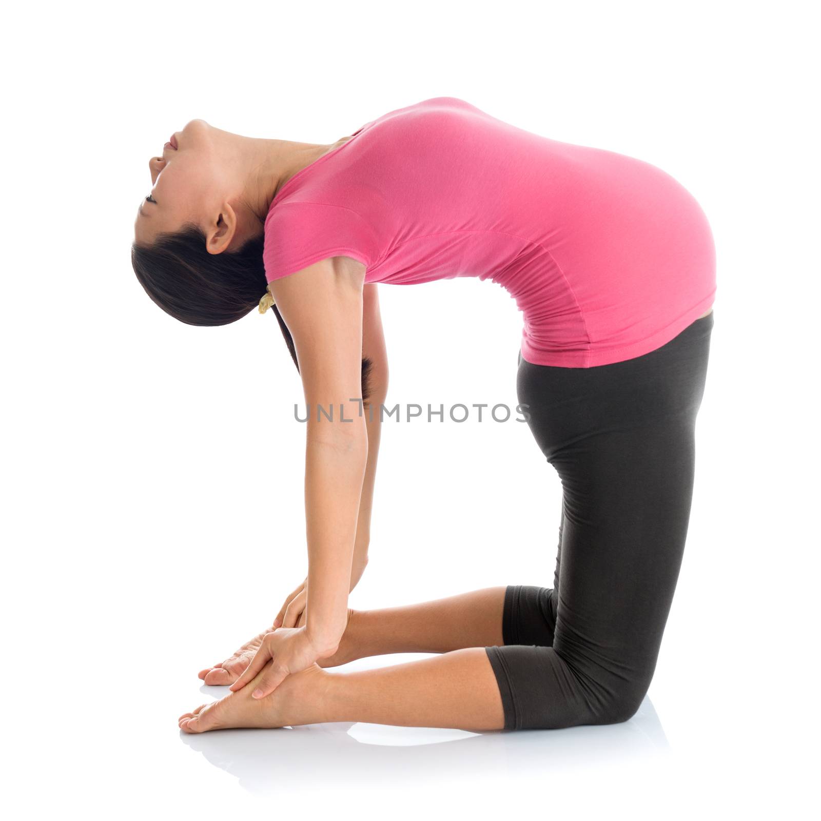 Prenatal yoga meditation. Full length healthy Asian pregnant woman doing yoga exercising stretching at home, fullbody isolated on white background. Yoga camel pose.
