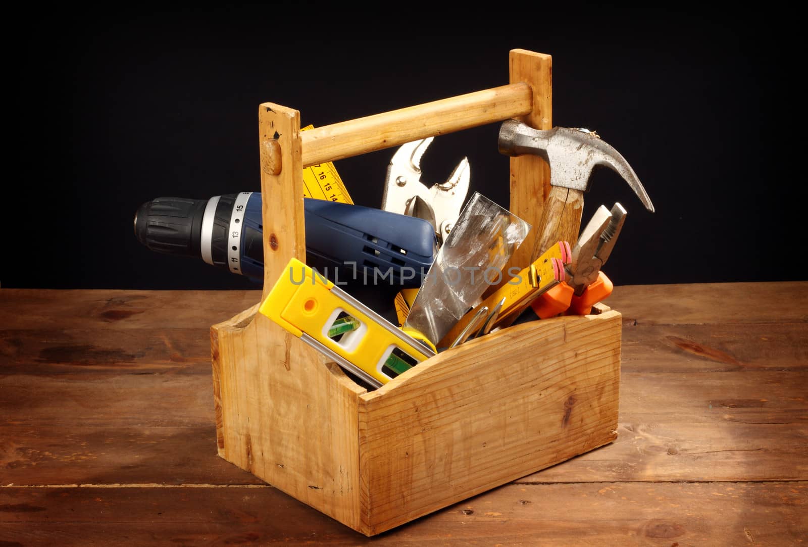 wooden tool box at work on a black background