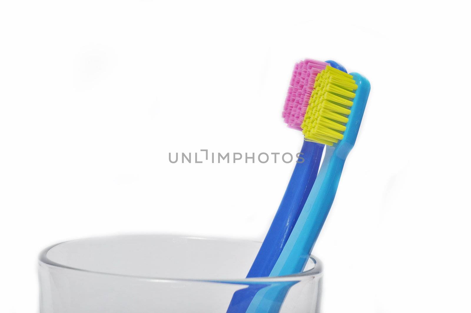 Colorful toothbrushes in a glass