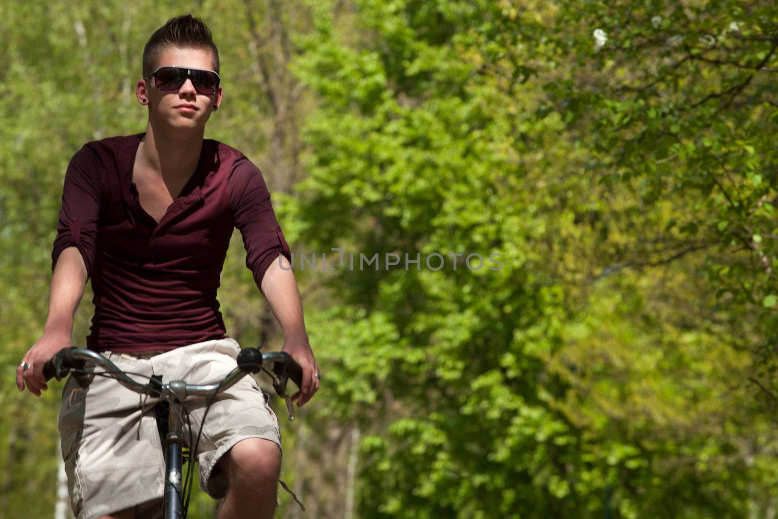 Young teenager is riding on his bicycle