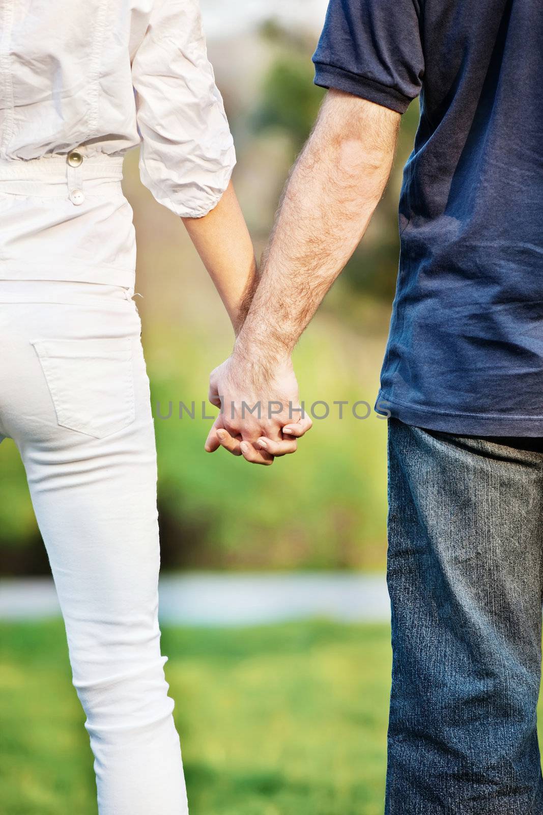 Young couple holding hands in park